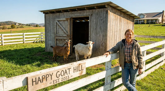 A wooden goat shed on an American homestead with goats and a farmer nearby