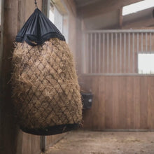 Goatzy slow feed hay bag in use: quick fill collar, mesh and hanging setup